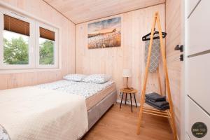 a bedroom with a bed and a ladder at Black Pearl in Dziwnów