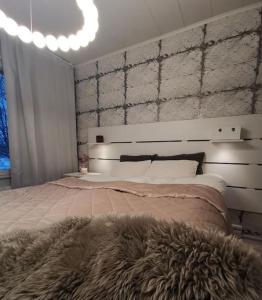 A bed or beds in a room at Rovaniemi - quality detached house with sauna nearby services