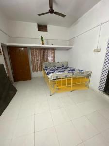 a bedroom with a bed and a ceiling fan at Morla’s villa in Jagdalpur