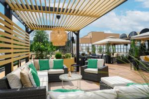 a patio with couches and chairs on a roof at Novotel Budapest City in Budapest