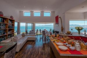 a living room with a table full of food at Sea Star Lodge in Gansbaai