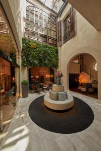 a lobby with a fountain in the middle of a building at Summum Boutique Hotel, member of Meliá Collection in Palma de Mallorca