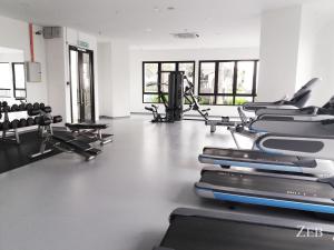 a gym with rows of treadmills and machines at i-City【CASA MILA】~Wifi/Netflix/Parking~7pax in Shah Alam