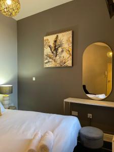 a hotel room with a bed and a mirror at Go Bright Double Studio in London