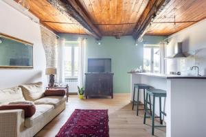 ein Wohnzimmer mit einem Sofa und einer Küche in der Unterkunft Adelaide al Borgo. in Castelnuovo di Porto