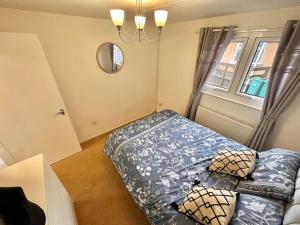 a bedroom with a bed and a mirror and a window at Semi-detached 1-Bedroom Chalet in Uddingston