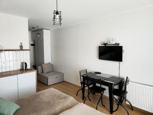 a living room with a table and a kitchen at Gudauri Vista 6 in Gudauri