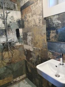 a bathroom with a sink and a shower at Vila Ula in Perloja