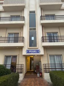a apartment building with a sign that reads parallel at Pearl Suites at Omaxe Eternity in Vrindāvan