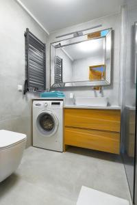 a bathroom with a washing machine and a sink at Na Bogówce in Zakopane