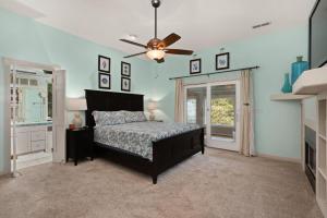 a bedroom with a bed and a ceiling fan at SH157 Chase-n-Grace in Southern Shores