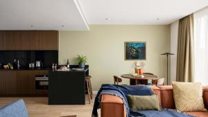 a living room with a couch and a table at Massive Studio with Garden In Leafy Canary Wharf Docklands Retreat in London