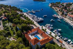 an aerial view of a house with boats in the water at Heritage Hotel Martinis Marchi in Maslinica