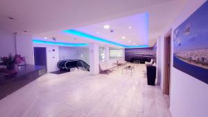 a large living room with blue lights on the ceiling at Eden Beach Apartment 207 in Limassol