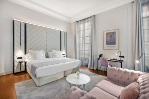 a hotel room with a bed and a couch at Summum Boutique Hotel, member of Meliá Collection in Palma de Mallorca