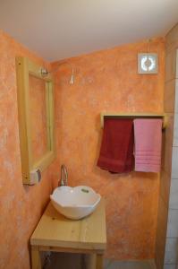 a bathroom with a sink and a mirror and towels at Studio Mini Lux in Požarevac +23 photos