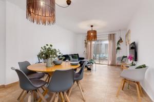 a dining room and living room with a table and chairs at Mi Patio in Torrevieja