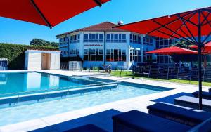 a large swimming pool in front of a building at Havellandhalle Resort in Seeburg