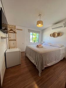 a bedroom with a bed and a television in it at Maré suites in Fernando de Noronha
