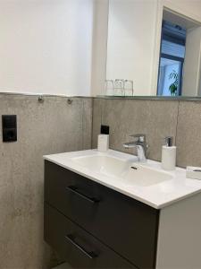 a bathroom with a white sink and a mirror at Ferienwohnung Eisele in Buchenberg