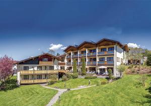 a large apartment building with a lawn in front of it at Glashotel in Zwiesel