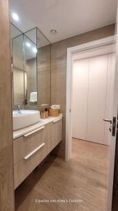 a bathroom with a sink and a mirror at Las Canteras con Alma in Las Palmas de Gran Canaria