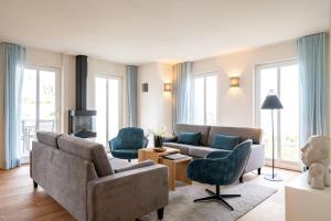 ein Wohnzimmer mit Couch und Sesseln in der Unterkunft Domizil Meerzeit, App. 7 in Ahlbeck