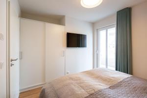 Ein Bett oder Betten in einem Zimmer der Unterkunft Domizil Meerzeit, App. 7