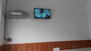 telewizor na ścianie w pokoju w obiekcie Hotel Rajput w mieście Bahādrābād