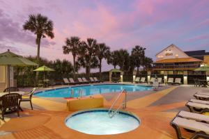 a large swimming pool with chairs and a building at Surfside Beach Oceanfront Hotel in Myrtle Beach
