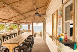a restaurant with a long table and chairs at Surfside Beach Oceanfront Hotel in Myrtle Beach