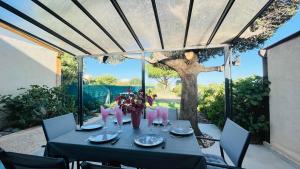 a table with glasses on top of it on a patio at Appartement Boug 2 Lumio in Lumio