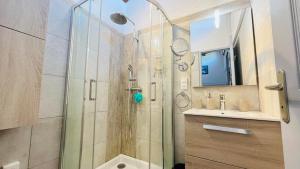 a shower with a glass door next to a sink at Appartement Boug 2 Lumio in Lumio +16 photos