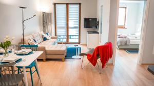 a living room with a couch and a table at Zielony Las, Sun & Snow in Krynica Zdrój +82 photos