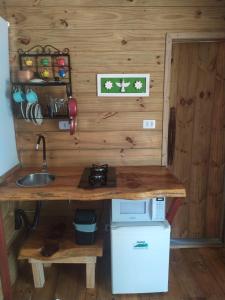 a kitchen with a counter and a sink in a room at Pousada Recanto dos Bentos in Itapeva
