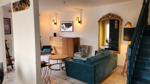 a living room with a couch and a table at Villa Yollande in Arcachon