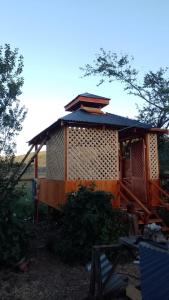 a large wooden house with a roof at Cabaña Queule in El Crucero