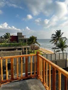 a balcony with a view of the ocean at Hotel Remember in Hikkaduwa