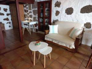 ein Wohnzimmer mit einem Sofa und einem Tisch in der Unterkunft Casa Aregume in Los Silos