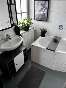 a bathroom with a sink and a bath tub and a sink at Bahnwärterhäuschen - 1873 in Feucht +23 photos