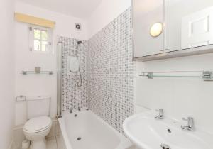 a white bathroom with a toilet and a sink at The Well Court Residence in Edinburgh