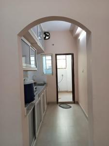 an empty kitchen with an archway in a house at 3-Bedroom Elegant and Spacious AC Apartment only for families, Prime Location, Just 100m from Main Road! in Hyderabad