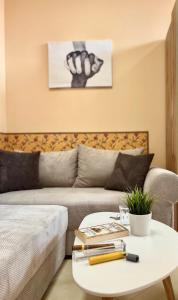 a living room with a couch and a table at Flower house 10 in Sofia