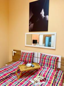 een slaapkamer met een bed, een tafel en een spiegel bij Flower house 10 in Sofia