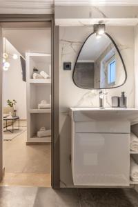 a bathroom with a sink and a mirror at Efrosini Apartments in Heraklio