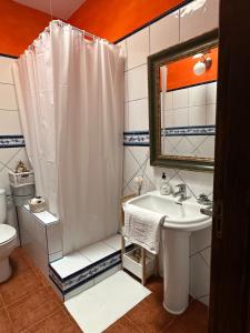 a bathroom with a white shower curtain and a sink at Habitación Dache Lanzarote in Tías