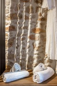 two towels sitting on a wooden shelf in a bathroom at Efrosini Apartments in Heraklio