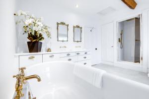 a white bathroom with a tub and a sink at Sparkenhoe House in Nuneaton