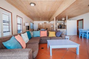 a living room with a couch and a table at Beachfront property, Victoria Bay, Garden route in Victoria Bay