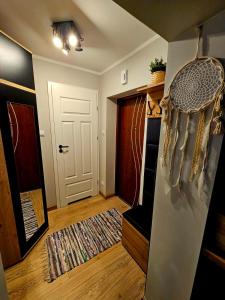 a room with a hallway with a door and a rug at Apartament Boho in Inowrocław